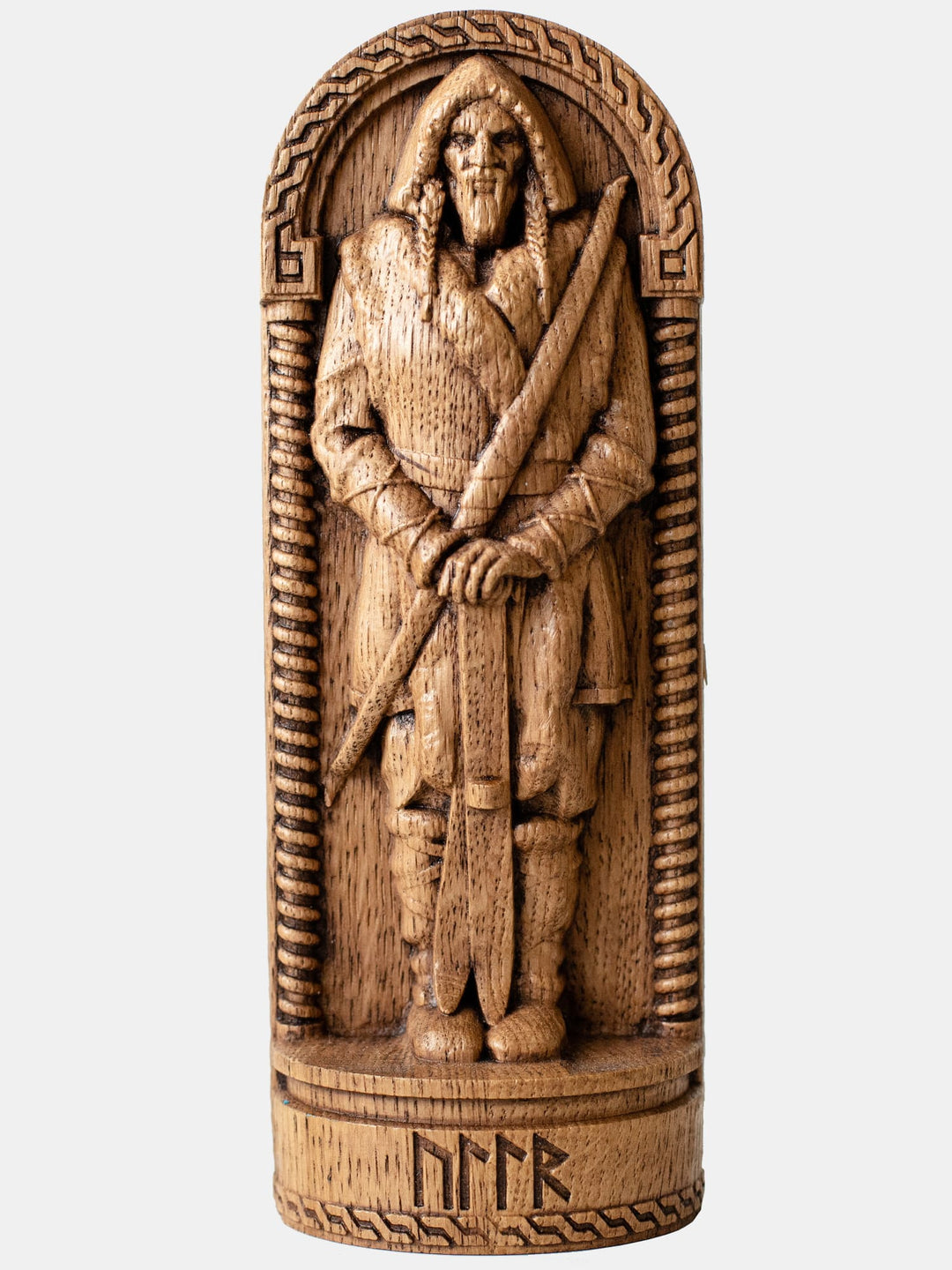 Close-up of the handcrafted oak Ullr statue, showcasing the Norse God of Winter holding a bow and skis in a simple style.