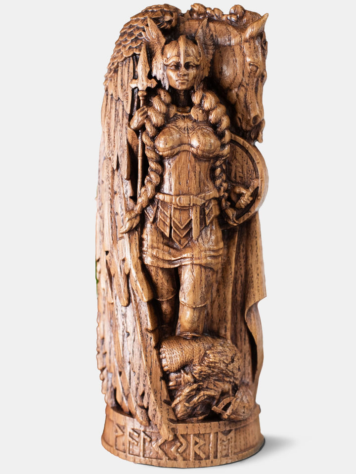 Close-up of the handcrafted oak Valkyrie statue, showcasing the Norse warrior maiden in armor with her winged horse in the background.
