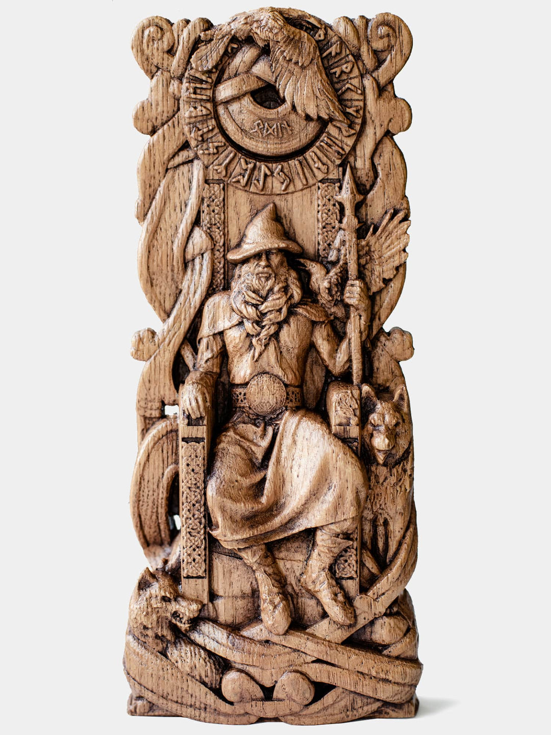 Close-up of the handcrafted oak Odin statue, showcasing the Norse All-Father seated on a throne surrounded by ravens and wolves, with a runic circle above his head.