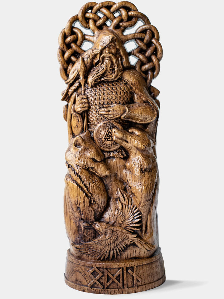 Close-up of the handcrafted oak Odin statue, showcasing the Norse All-Father against the backdrop of Yggdrasil, combining his traveler and warrior personas.