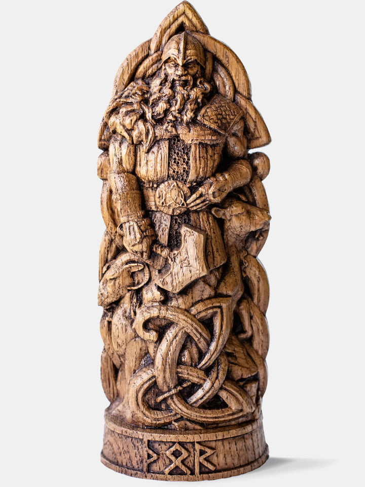 Close-up of the handcrafted oak Thor statue, showcasing the Norse God of Thunder holding his hammer, with magical gauntlets and belt.